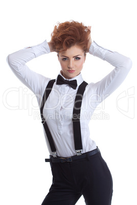 Cute redhead girl posing in suit with suspenders