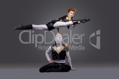 Image of go-go dancers posing in acrobatic pose