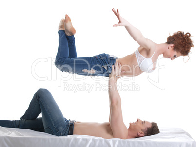 Smiling flexible lovers looking at each other