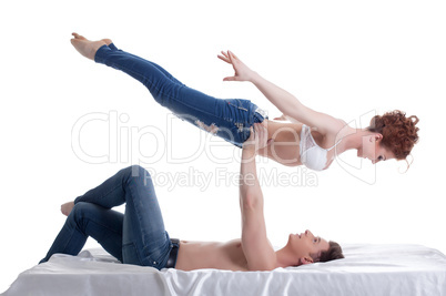 Image of attractive young gymnasts posing in bed