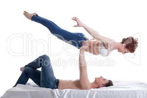 Image of attractive young gymnasts posing in bed