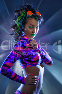 Beautiful slim woman posing with neon makeup