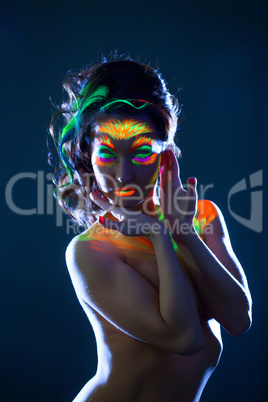 Sensual woman posing with glowing in dark makeup