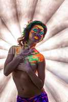 Pretty girl posing topless with fluorescent makeup