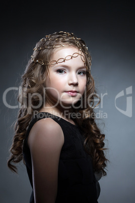 Adorable girl with gold decoration on her head