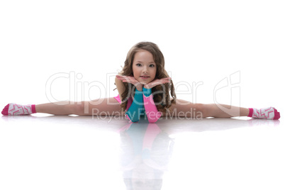 Smiling curly gymnast sitting on splits