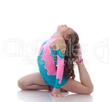Adorable little gymnast doing stretching exercises