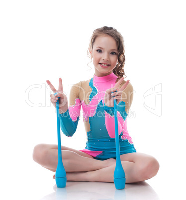 Cheerful little gymnast posing with mace