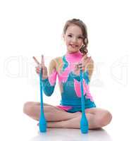 Cheerful little gymnast posing with mace