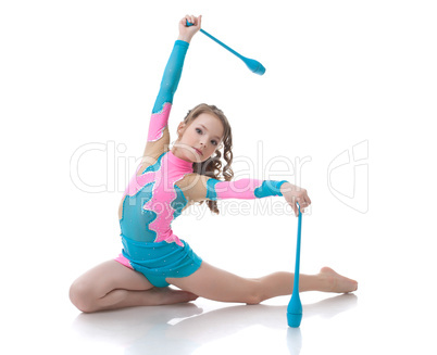 Adorable girl exercising with gymnastic mace