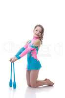 Smiling little girl posing with gymnastic mace