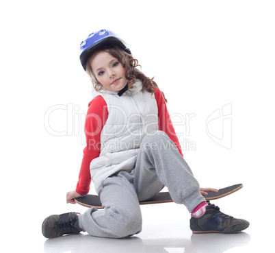 Curly little skateboarder posing at camera