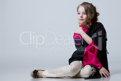 Adorable fashionable little girl posing in studio