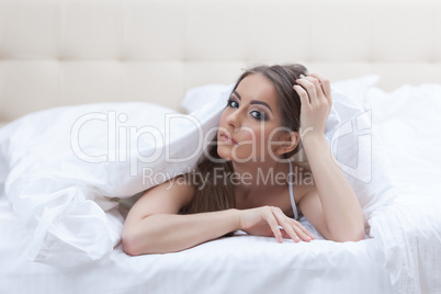 Portrait of sexy girl posing covered with blanket