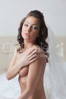 Portrait of pretty topless girl posing in veil