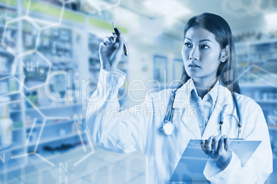 Composite image of asian doctor pointing with pen