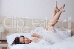 Sexy bride posing naked lying in hotel bed