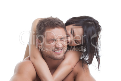 Portrait of happy couple embracing in studio