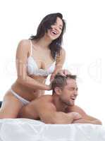Image of cheerful young lovers posing in bed