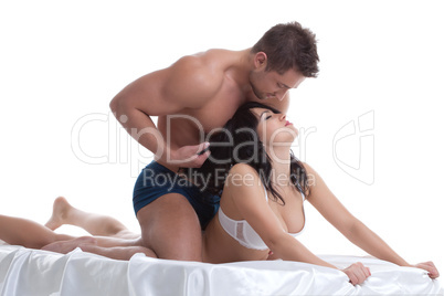 Foreplay of young lovers lying in bed