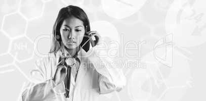 Composite image of asian doctor holding her stethoscope