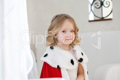 Portrait of adorable little girl in royal mantle