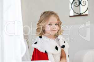 Portrait of adorable little girl in royal mantle