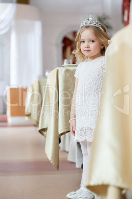 Image of lovely little girl posing in restaurant