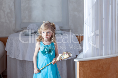 Confused blue-eyed girl posing in elegant dress