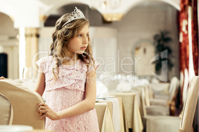 Smartly dressed little lady posing in restaurant