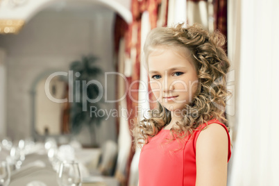 Portrait of lovely curly girl in restaurant