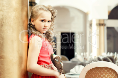 Beautiful girl posing in elegant dress with mask