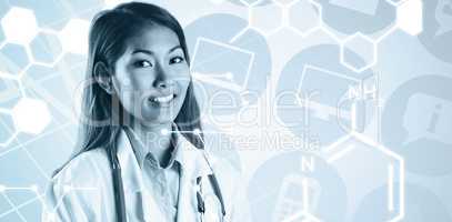 Composite image of asian doctor with stethoscope looking at came