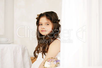 Portrait of cute brown-eyed girl with curly hair
