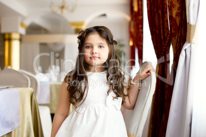 Beautiful little fashionista posing in restaurant