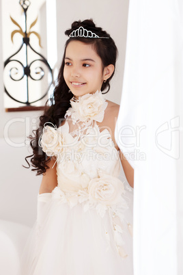 Portrait of pretty little girl in chic white dress