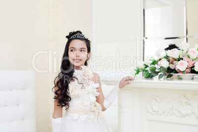 Lovely tanned girl posing in elegant white dress