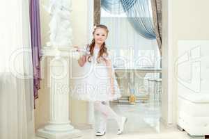 Adorable little girl posing in elegant dress