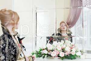 Young actress looking at her reflection in mirror