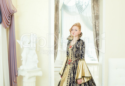 Charming young woman posing in deluxe king costume