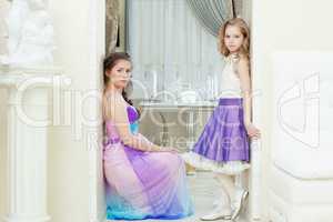 Enchanting young models posing in elegant dresses