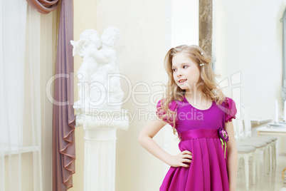 Smiling blonde model posing in magenta dress