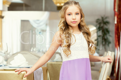 Charming long-haired girl posing in restaurant