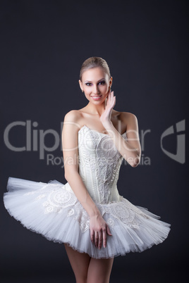 Young charming ballerina posing smiling at camera