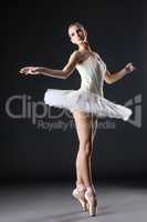 Image of cute young ballerina dancing in studio