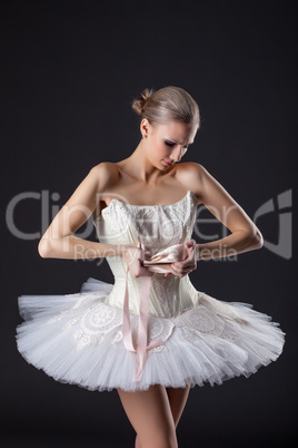 Concentrated pretty ballet dancer kneads pointe