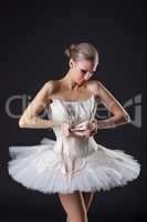 Concentrated pretty ballet dancer kneads pointe