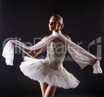 Portrait of cute young woman posing like ballerina