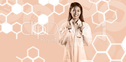 Composite image of asian doctor holding stethoscope