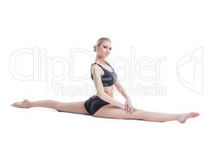Lovely flexible girl posing sitting on splits